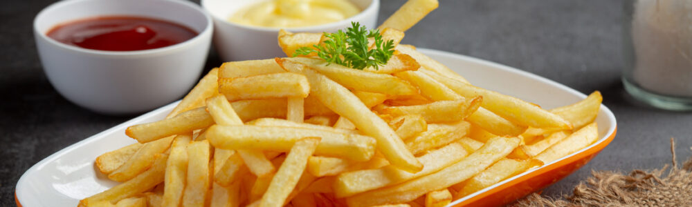 Crispy French fries with ketchup and mayonnaise.