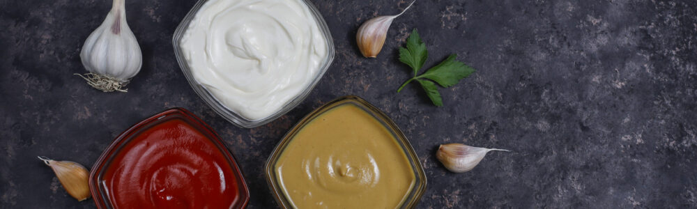 Homemade ketchup,mustard and mayonnaise sauce and ingredients on